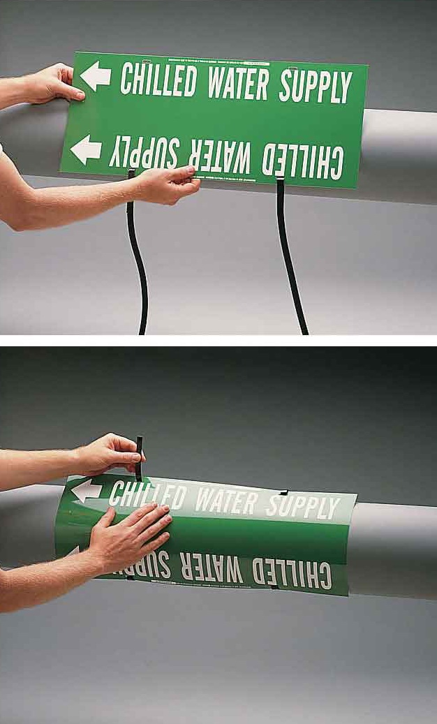 Close-up of someone applying a green Brady strap-on pipe marker